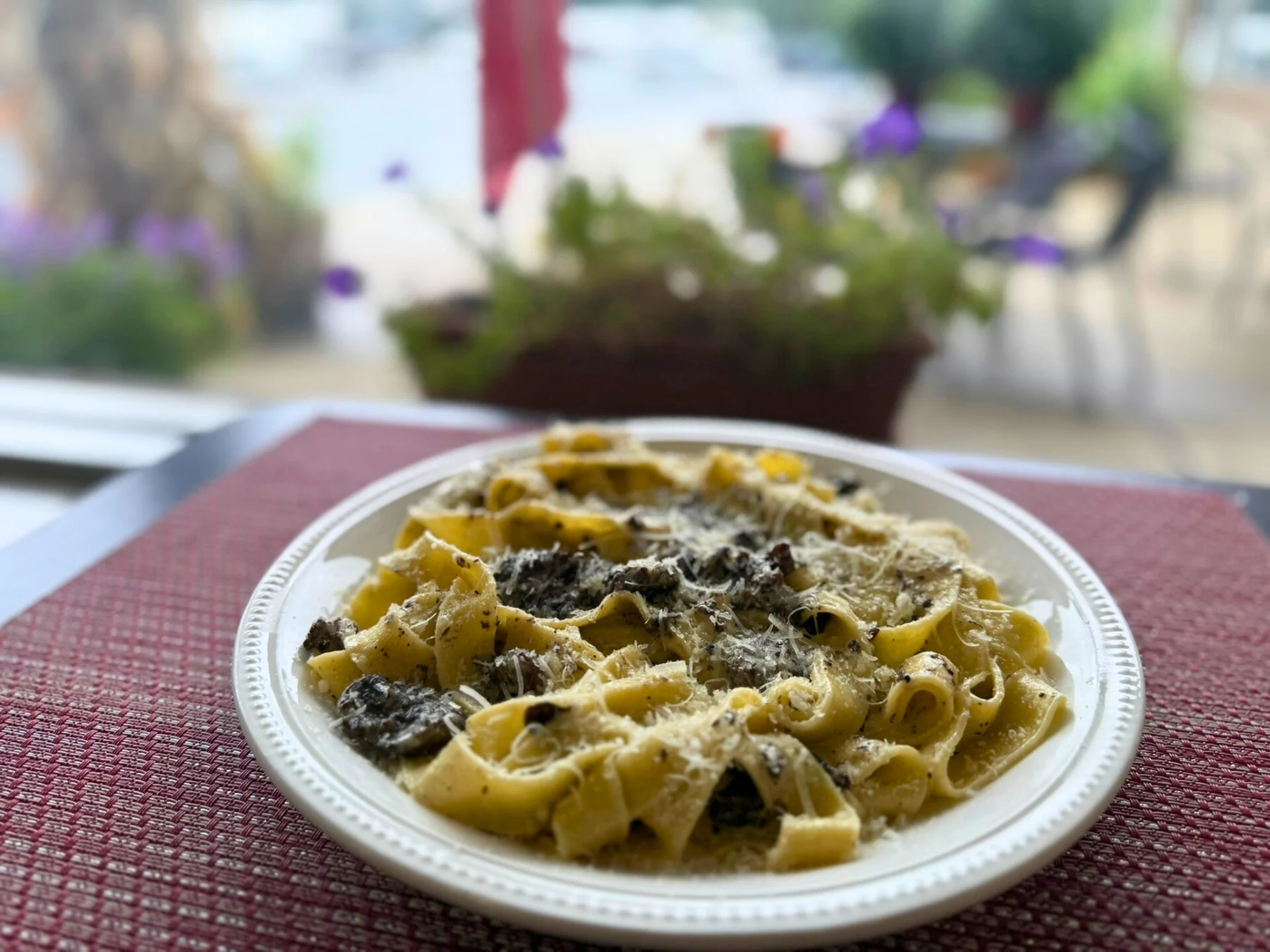 A plate of Eataliana pasta with shaved cheese